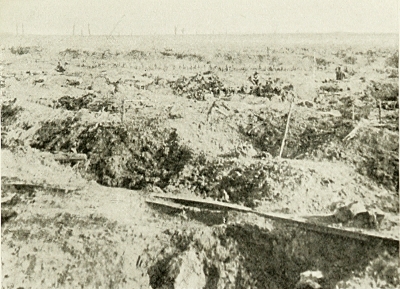 THE BATTLEFIELD OF "GINCHY." I WAS HURLED INTO THE TRENCH
IN THE FOREGROUND BY THE BURSTING OF A GERMAN SHELL, AND AWOKE
MANY HOURS LATER WITH SHELL SHOCK AND REALISED I HAD BEEN
LYING BESIDE A DEAD GERMAN ALL NIGHT. HE HAD BEEN THERE
I SHOULD SAY ABOUT THREE WEEKS