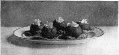 TOMATOES STUFFED WITH CELERY AND MAYONNAISE STANDING ON
LETTUCE LEAVES.