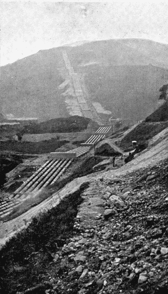 By permission of the British Aluminium Co

A Striking Feature of Modern Aluminium Works

For the production of aluminium water power is required. Water is stored at a high
level and is then brought down to the factory in pipes. The illustration shows the pipe
track recently laid down for this purpose at Kinlochleven in Argyleshire. The six pipes,
each of which is thirty-nine inches in diameter, run down the hillsides for one mile and
a quarter