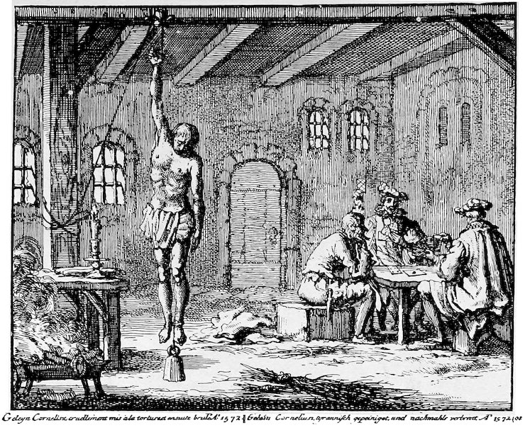 A black-and-white historical engraving depicting a scene of torture inside a stone dungeon or chamber. On the left, a partially nude man hangs suspended from the ceiling by one wrist, with a heavy weight attached to his feet. On the right, a group of men in Renaissance-era clothing sit casually around a wooden table, conversing and playing cards while ignoring the prisoner.