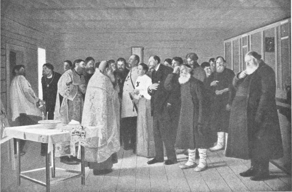 An assembly of people gathered in a room face three priests in front of a makeshift altar.