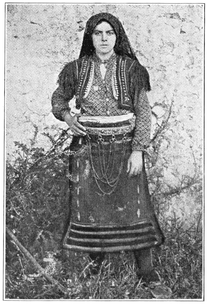 full-length photo of woman in native dress, facing viewer